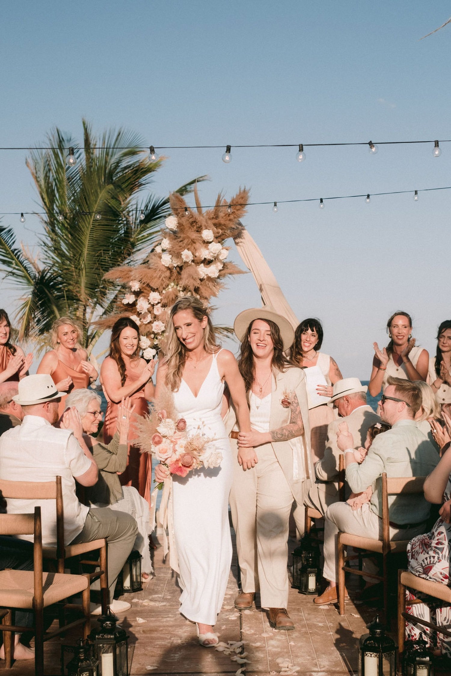 Just-married-couple-exiting-the-ceremony-at-Akna-Tulum,-joyful-celebration-with-guests-cheering.jpg (1)
